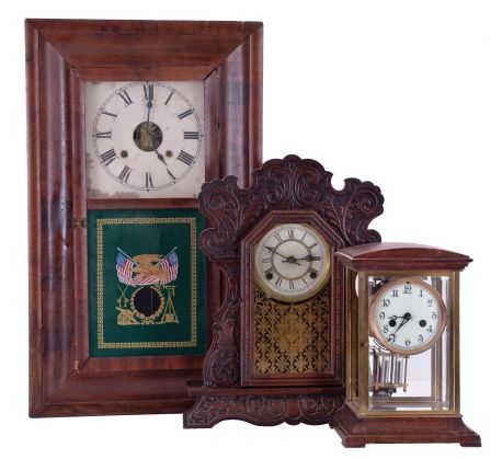 Clocks- 3 (Three) American Mantel: (1) Waterbury Clock Co., Waterbury Conn., crystal regulator, 8 day time and strike, spring driven movement with simulated mercury pendulum in case with wooden top and bottom; (2) Waterbury Clock Co., Waterbury Conn., "Unity", 8 day time and gong strike, spring driven movement shelf clock in a walnut case; (3) William S. Johnson, NY, OOG mantel clock, unsigned 30 hour time and strike weight-driven movement in a mahogany veneered case.