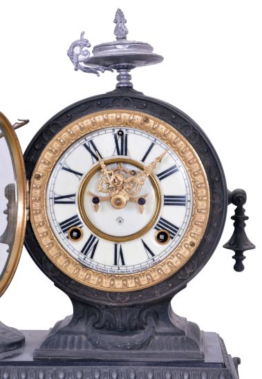 Ansonia Clock Co., New York, NY, "Cupid" figural mantel clock with an 8 day spring driven time and half hour strike movement with visible escapement in a cast metal case.