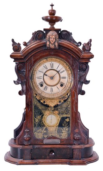 Ansonia Clock Co., New York, NY, "Monarch" mantel clock with 8 day, spring driven time and strike movement, in a walnut case with applied metal ornaments, patented pendulum, and dedication plaque dated 1892.