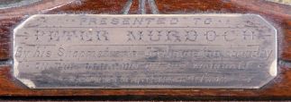 Ansonia Clock Co., New York, NY, "Monarch" mantel clock with 8 day, spring driven time and strike movement, in a walnut case with applied metal ornaments, patented pendulum, and dedication plaque dated 1892.