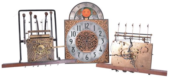 Clock parts- (1) One modern tall clock case in oak; (2) 8 day weight driven 5-tube chime tall clock movement by Jauch; (3) Electrically driven 5-tube chiming tall clock movement by Revere Clock Co. of Cincinnati, OH with Telechrone synchronous motor and dial; (4) 6 sets of tubular chimes: one set of four, one set of seven, and four sets of five; (5) three tall clock pendulums.