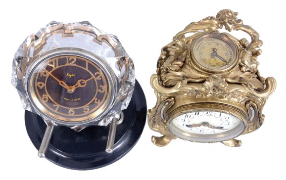 Clocks- 2 (Two) Desk Clocks: (1) France, desk compendium with aneroid barometer and two thermometers, 8 day, time and strike balance wheel movement in a Rococo revival brass case holding a polychrome enamel dial; (2) Majak, USSR, desk clock with balance wheel movement in a Mid-century Modern cut and polished crystal case held by two curved supports mounted to a black plastic base.