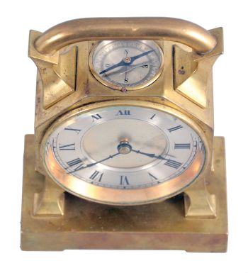 France, desk clock, 8 day timepiece with balance wheel movement and directional compass on a brass base supporting an octagonal case on four feet, topped with a handle, c1900.