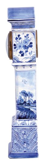 France, ceramic miniature tall clock, the earthenware case with blue, freehand decoration on a white ground, depicting harbor scenes with windmills on the trunk and base, with naturalistic ornament on the bonnet and base sides, Roman numeral white enamel dial with gilt Louis XV style hands, 8 day timepiece movement with cylinder platform, case bottom with makers mark