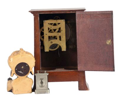 Clocks- 3 (Three) Desk and Novelty: (1) American Clock Co., Chicago, mantel clock, 8 day time only, spring driven movement in an inlaid mahogany case with white enamel dial showing Arabic numerals, c1930; (2) J. Oswald, Germany, "Sheik" rotating eye novelty clock of a seated figure with large earrings and turban with outstretched arms, c1950; (3) E.N. Welch, Forestville, Conn., "Little Corinne" miniature carriage clock, 30 hour time only movement in a nickel case with white enamel dial, c1889.