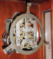 Ansonia Clock Co., New York, NY, "Capitol" wall hanging clock with a spring driven, 8 day timepiece movement in an oak case.