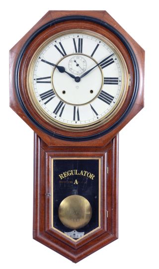 Ansonia Clock Co., New York, NY, "Regulator A" hanging clock with a spring driven, 8 day, time and strike movement in a walnut case.