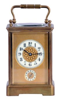 France, for Shreve, Crump & Low, Boston, striking carriage clock with alarm, brass Corniche case with beveled glasses, Arabic numeral white enamel dial with gilt mask, and subsidiary alarm chapter, blued steel distaff style hands, 8 day striking movement with lever platform, sounding the hour and half hour in passing