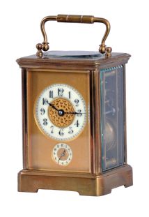 France, for Shreve, Crump & Low, Boston, striking carriage clock with alarm, brass Corniche case with beveled glasses, Arabic numeral white enamel dial with gilt mask, and subsidiary alarm chapter, blued steel distaff style hands, 8 day striking movement with lever platform, sounding the hour and half hour in passing