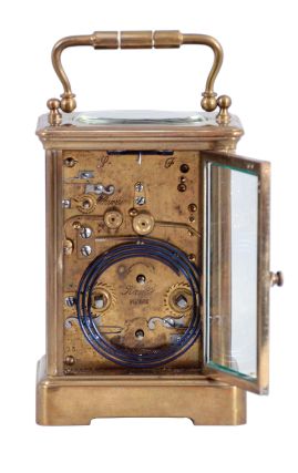 France, for Shreve, Crump & Low, Boston, striking carriage clock with alarm, brass Corniche case with beveled glasses, Arabic numeral white enamel dial with gilt mask, and subsidiary alarm chapter, blued steel distaff style hands, 8 day striking movement with lever platform, sounding the hour and half hour in passing