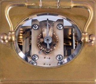 France, for Shreve, Crump & Low, Boston, striking carriage clock with alarm, brass Corniche case with beveled glasses, Arabic numeral white enamel dial with gilt mask, and subsidiary alarm chapter, blued steel distaff style hands, 8 day striking movement with lever platform, sounding the hour and half hour in passing