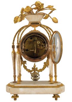 French: Merra, Paris, mantel clock, 8 day, time and strike, count wheel and bell movement with silk thread suspension by Vincenti & Cie., Paris. White marble case with gilt hardware, fluted columns and twisted arched supports, the top with large gilt roses in bloom. Signed white porcelain dial with Roman numerals.