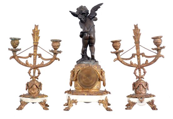 Mini clock set- France, 8 day, time only balance wheel movement behind white enamel dial with polychrome floral design on a white marble base with gilt claw feet supporting a cast fluted pedestal, surmounted by a patinated spelter figure of Cupid drawing his bow. Set is completed by two matching candelabra, both holding two candles each.