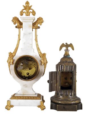 Clocks- 2 (Two) French: (1) Lyre form time only mantel clock, white marble with gilt brass mounts, male faces and rooster heads on opposite sides, the top with floral finial. White enamel dial with polychrome floral pattern and faux winding arbor; (2) Brass time only mantel clock in the form of a truncated fluted column, wreath bezel surrounding a silvered dial with Arabic numerals, supporting a small eagle with wings outstretched.