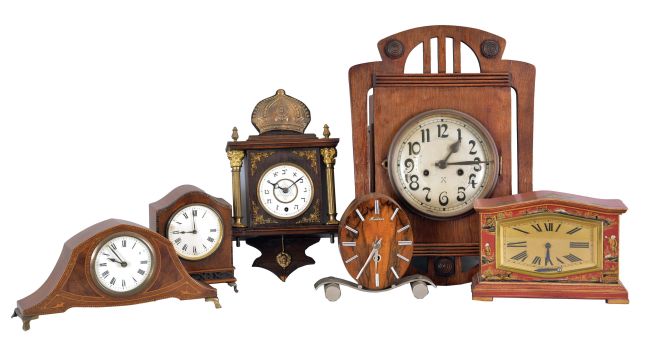 Clocks- 6 (Six) French and German Desk and Wall: (1) France, mantel clock, 8 day time only platform movement in a red wood case with Asian inspired design; (2) Hamburg American Clock Co., Germany, wall clock, 8 day, time and strike, spring driven clock in a oak case with silvered metal dial; (3) France, desk clock, 8 day, time only with a cylinder escapement in a walnut and mahogany veneered case with white paper dial; (4) Germany, desk clock, 8 day, time only in an inlaid mahogany case with white enamel dial; (5) France, "Montana" desk clock, 8 day, time only balance wheel movement in a Mid-Century Modern figured veneer case; (6) Germany, wall clock, 30 hour time only, spring driven in a dark wood case with metal columns and spandrels with a white enamel dial featuring a star of David and numerals in Hebrew.