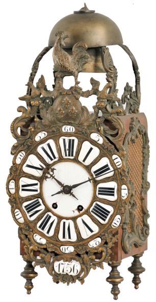France, lantern clock, walnut case with ornate cast front incorporating the dial, side frets with rococo ornament, and top with fancy bell cage and two bells, surmounted by a rooster finial, Roman numeral white enamel cartouche dial with enamel center, blued steel hands, 8 day, time and strike movement with square plates