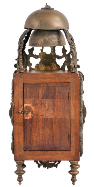 France, lantern clock, walnut case with ornate cast front incorporating the dial, side frets with rococo ornament, and top with fancy bell cage and two bells, surmounted by a rooster finial, Roman numeral white enamel cartouche dial with enamel center, blued steel hands, 8 day, time and strike movement with square plates