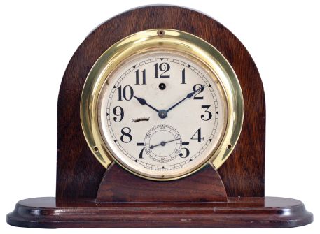 Seth Thomas Clock Co., Thomaston, Conn., "Ships Lever" pilot house clock, cast brass case with mounting flange and screw on bezel, Arabic numeral silvered dial with large seconds at 6:00, blued steel hands, 8 day timepiece movement with steel pinions and lever escapement, now mounted to a purpose made stand 