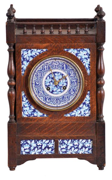 French, oak cased mantel clock with blue and white inserts and dial, 8 day, time and strike, with a movement stamped "C. J. & Co.", the case with turned corner columns and finials.