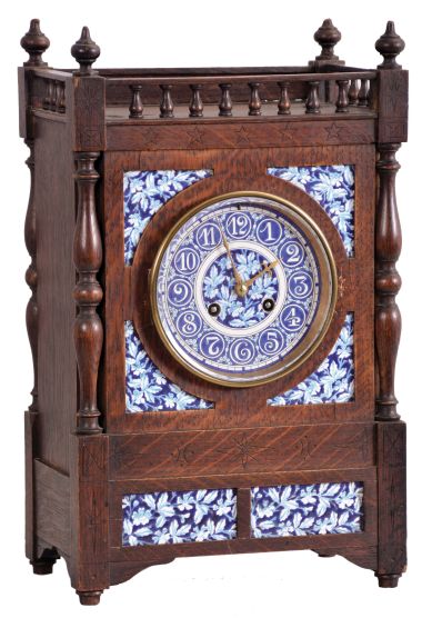 French, oak cased mantel clock with blue and white inserts and dial, 8 day, time and strike, with a movement stamped "C. J. & Co.", the case with turned corner columns and finials.