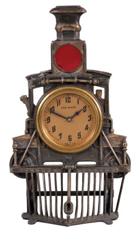 New Haven Clock Co., New Haven, Conn., novelty clock, 30 hour time only movement in a cast metal case resembling the front of locomotive complete with cow catcher and red glass lens, c1920