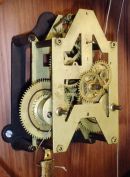 Ansonia Clock Co., New York, NY, "Santa Fe" wall hanging clock with a double weight driven timepiece movement in a walnut case.
