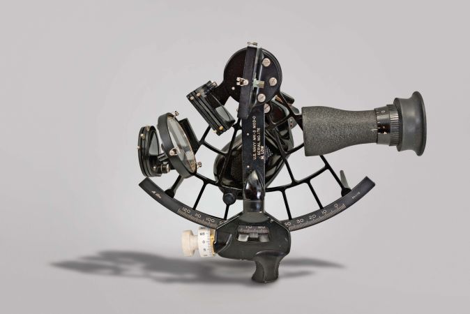 M. Low, New York, for U.S. Navy "US Navy MK-3, Mod-0" sextant, 6.5 inch radius, black metal frame, Navy identification on index arm and mount for index mirror, graduated arc reading 0-120, micrometer drum, shades for horizon and index mirrors, sighting scope, and black plastic handle with battery compartment, all in mahogany box with plaque reading "U.S. Naval Ships Systems Command" with a certificate dated 1970.