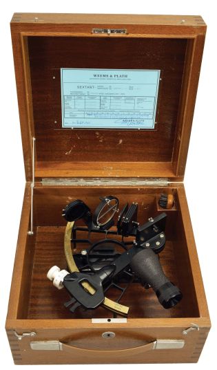 Weems & Plath, Germany, "Micrometer Sextant with Astigmatizer Lens", 160mm radius, metal frame with black finish, signed brass arc with graduations from -5 to125, micrometer vernier adjustment, multiple shades for horizon and index mirrors, 4x40 sighting scope, lighting lamp, and black plastic handle, all in a finger-jointed mahogany box with a certificate under the lid dated 1976.