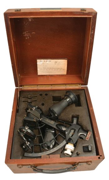 M. Low, New York for U.S. Navy, "Mark III, Model 0" sextant, 6.5 inch radius, black metal frames, Navy identification on index arm and rear of index mirror holder, graduated arc reading -5 to125, micrometer drum, shades for horizon and index mirrors, sighting scopes, push-button illumination, and black plastic handle, all in wood box with certificate under the lid dated 1973.