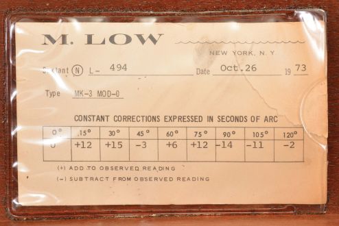 M. Low, New York for U.S. Navy, "Mark III, Model 0" sextant, 6.5 inch radius, black metal frames, Navy identification on index arm and rear of index mirror holder, graduated arc reading -5 to125, micrometer drum, shades for horizon and index mirrors, sighting scopes, push-button illumination, and black plastic handle, all in wood box with certificate under the lid dated 1973.