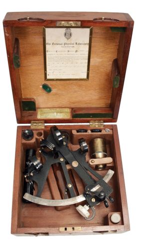 H. Hughes & Son Ltd., London, 7 inch sextant, pierced metal frame with black crinkle finish, signed brass arc with silvered scale, the graduations from -10 to 135, micrometer drum adjustment, index lamp, multiple shades for horizon and index mirrors, sighting scopes, and wood handle with battery compartment, all in finger-jointed mahogany box with a certificate from the National Physical Laboratory with a signature from its director, Sir C.G. Darwin dated 1940.