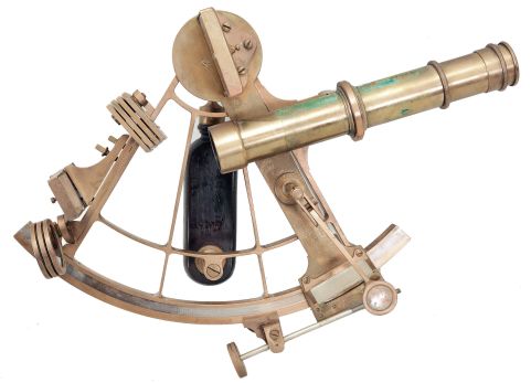 Keuffel & Esser Co., New York, for U.S. Navy, brass sextant, 6 inch radius, pierced brass frame, signed brass arc with inset silvered arc graduated from -5 to 145, outboard tangent screw for vernier adjustment, index with magnifier and frosted glass shade, multiple shades for index and horizon mirrors, three sighting telescopes, and ebony handle, all in a dovetailed mahogany box with accessories, inset Naval plaque, paper labels, and certificate under the lid dated 1918.