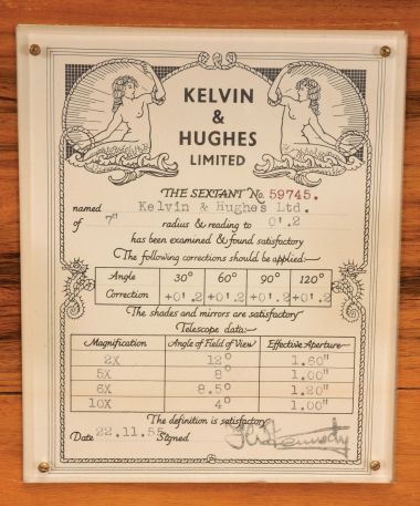 Kelvin & Hughes Ltd., London, 7 inch radius sextant, pierced black metal frame, signed brass arc with inset silvered arc graduated from -5 to 125, index arm with K&H logo, micrometer drum vernier adjustment, index lamp, multiple shades for index and horizon mirrors, sighting telescopes, auxiliary lamp, and black plastic handle with battery compartment all in a finger-jointed case with certificate under the lid dated 1955.