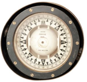 E.S. Ritchie & Sons, Pembroke, MA, brass binnacle, 5 inch liquid-filled compass on gimballed mount covered by a domed brass lid with two sliding doors flanked by lid handles, all on a cylindrical brass stand with flange base.