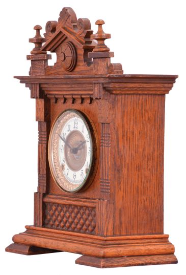 Ansonia Clock Co., New York, "Salem" cabinet shelf clock with a spring driven, 8 day, time and half hour strike movement in an oak case.