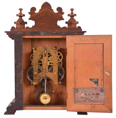 Ansonia Clock Co., New York, "Salem" cabinet shelf clock with a spring driven, 8 day, time and half hour strike movement in an oak case.