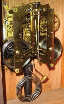 Ansonia Clock Co., New York, "Salem" cabinet shelf clock with a spring driven, 8 day, time and half hour strike movement in an oak case.