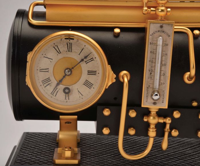 France, a rare, gilt and patinated, automated steam engine compendium, the horizontal boiler mounted to a cast floor with crosshatched surface, and resting on a black slate base, boiler fitted with an 8 day, timepiece and aneroid barometer, both with silvered dials and flanking the central thermometer with silvered scale, and surmounted by the engine flywheel, governor, cylinder and valve, the flywheel, piston, and governor powered by a movement concealed in the cylinder, the motion started and stopped through the screw in the cylinder valve, the valve front with plaque marked "D. H. Depose"