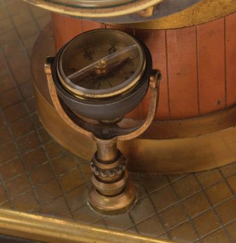France- Andre Romain Guilmet, a rare Industrial steam boiler compendium with centrifugal governor pendulum, the stepped black slate base supporting a compass on a decorative stand, before a boiler with gilt and patinated silver surfaces and ribbed, copper base matching the clock case, the top having a cylindrical chamber with vent pipes attached to gauge form, flanking, white dialed thermometer and barometer, and concealing the helical suspension spring controlling the centrifugal governor form pendulum, Arabic numeral gilt dial, blued steel distaff hands, and 8 day pendule de Paris time and strike movement with Guilmet