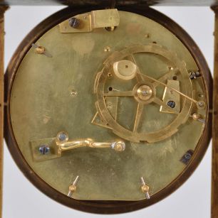 Robin Pere, a Paris, a marble and gilt bronze mystery clock, the variegated, green marble, portico style case with fluted pilasters flanking the dial, and supporting the entablature, surmounted by a gilt column with eagle finial, with knife edge stud for suspending the gridiron pendulum, signed, Roman numeral white enamel dial with pierced and engraved gilt hands, 8 day, two train movement striking the hours and half hour in passing,