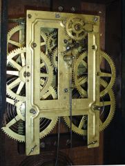 Brewster Manufacturing Co., Bristol, Conn., 8 day, time and strike, spring brass movement serpentine front shelf clock with gilt decoration.