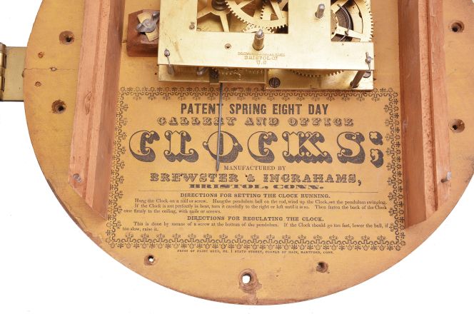 Brewster & Ingrahams, Bristol, Conn., Gallery hanging clock with an 8-day spring driven East-West timepiece movement with a brass spring in a crotch mahogany case.