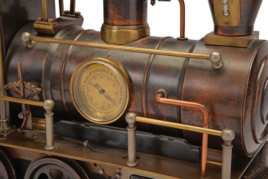 France, a rare, automated, patinated bronze locomotive form compendium, the stepped, black slate base on gilt feet with patinated rails below the large, steam locomotive, the darker surfaces highlighting the nickel, brass, and copper appointments, the engine front with cow catcher, the boiler with aneroid barometer, bell, steam dome with valve and flared stack with centigrade thermometer, the cab with shallow pitched roof, slender columns at the corners, and containing the clock and dial, a concealed movement in the base providing power to drive the six wheels, connecting rods, and piston, roman numeral brass dial, blued steel Breguet style hands, and 8 day, two train pendule de Paris movement