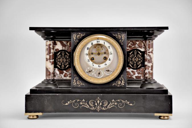 France for the English market, mantel clock, 8 day, time and strike with perpetual calendar showing the days, date, and months in English, spring driven movement with Brocot escapement in a black slate case with variegated marble columns and insets, enameled dial with subsidiary for the calendar functions.