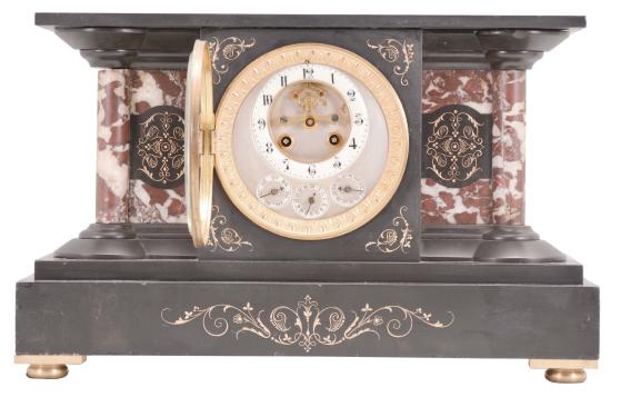 France for the English market, mantel clock, 8 day, time and strike with perpetual calendar showing the days, date, and months in English, spring driven movement with Brocot escapement in a black slate case with variegated marble columns and insets, enameled dial with subsidiary for the calendar functions.