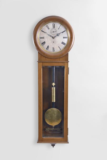 Seth Thomas Clock Co., Thomaston, Conn., "Regulator No. 62" wall clock, 8 day, time only, weight driven movement in a mahogany case with meter long pendulum, maintaining power and silvered dial