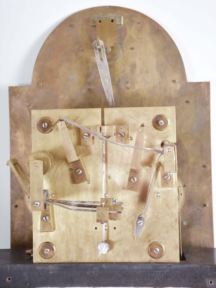 England, a good early 20th century inlaid mahogany tall clock, the bracket feet supporting a base with mahogany and satinwood cross-banded frame with inset panel having floral marquetry and scrolled foliate border, the trunk door also with satinwood cross-banding surrounding a neoclassical urn with bellflower and trailing vine, terminating in a lion