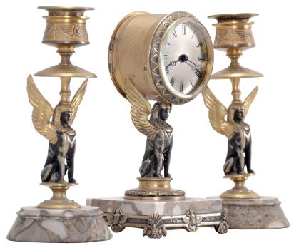 France, Egyptian Revival three piece garniture, 8 day, time only, spring driven brass movement with cylinder escapement in a brass drum supported by a cast winged sphinx figure seated on a variegated marble base with cast moldings, silvered roman numeral dial, and Breguet style blued steel hands