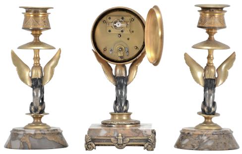 France, Egyptian Revival three piece garniture, 8 day, time only, spring driven brass movement with cylinder escapement in a brass drum supported by a cast winged sphinx figure seated on a variegated marble base with cast moldings, silvered roman numeral dial, and Breguet style blued steel hands
