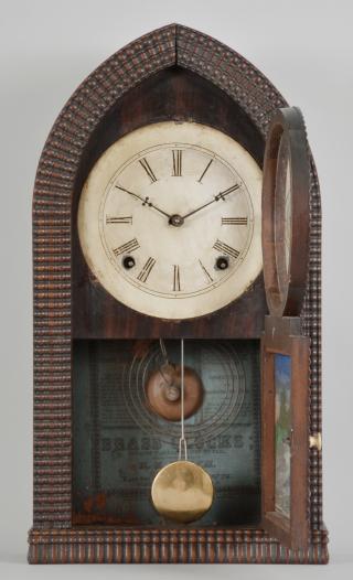 E.N. Welch Mfg. Co., Forestville, Conn., 8 day, time and strike spring driven brass movement ripple-front round gothic or " beehive" shelf clock.